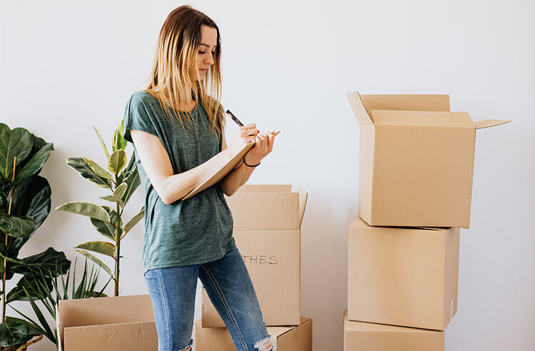 Women making list on moving boxes