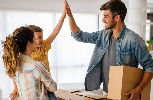 Image of a man high-fiving his son while mom holds him